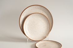 two white and brown plates sitting next to each other