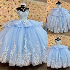 a blue ball gown with white flowers on it