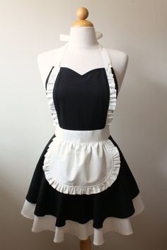 a mannequin wearing a black and white apron