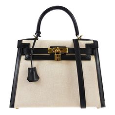 Hermes * Kelly 28 Sellier 2way Shoulder Handbag Beige Black Toile H Box Calf    Engraved / Number :  14C □ F ;Production in 2002    Pocket :  Outside: -, Inside: Zipper Pocket*1, Pocket*2    Size(Inch) :  W 11.4 x H 8.7 x D 4.7 " Handle Drop. 3.5 ", Strap Drop. 17.7 "    Size(cm) :  W 29.0 x H 22.0 x D 12.0 cm Handle Drop. 9.0 cm, Strap Drop. 45.0 cm    Color / Material :  Beige, Black / Toile H, Box Calf    Comes with :  Shoulder Strap, Padlock, Key x2, Key cover, Dust Bag, Dust Bag for Shoulde Black Toile, Hermes Kelly 28, Key Cover, Top Handle Bags, Key Covers, Shoulder Handbag, Shoulder Handbags, Top Handle, Zipper Pocket