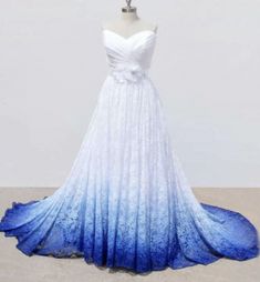 a white and blue wedding dress on display