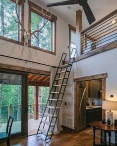 a living room with stairs leading up to the loft