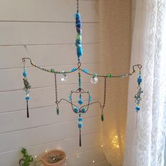 a chandelier hanging from the ceiling next to a toilet in a room with white walls