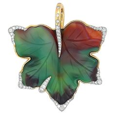 A deep earth toned agate is the focus of this leaf pendant trimmed with brilliant cut diamonds. Agate is carved in the contour of a five-pointed leaf, displaying the translucency of the gem, as shades of emerald and red brown blend into each other. Agate is a type of chalcedony with natural inclusions that create astounding patterns, while remaining durable to wear. Adorning the points of the leaf are brilliant cut diamonds of DEF color and VS clarity, producing a clean glimmer across its facets 1stdibs Chanel, Chanel Flower, Gold Leaf Pendant, Vintage Necklaces, Filigree Pendant, Gold Locket, Yellow Gold Setting, Enamel Flower, Flower Jewelry