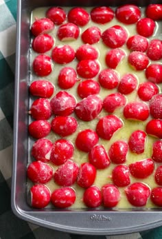 a pan filled with red and white food on top of a checkered table cloth