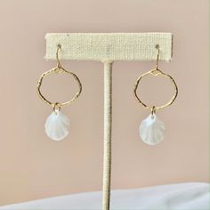 BEACHY CHIC SHELL EARRINGS -White acrylic faux shell    ANTI-TARNISH GOLD FINISH -Durable for long term wear. SAFE FOR SENSITIVE SKIN  -Gold-plated hooks  -Free of nickel, lead, & metals that irritate the skin -Will not turn skin green -Very lightweight on the ears SIZE  Length of earring: ~1.8" SOLD AS A PAIR You will receive 1 pair of earrings (2 total pieces) Beachy Chic, Coastal Jewelry, Earrings Gold Hoop, Dangle Earrings Gold, Seashell Earrings, Earrings Summer, Chic Earrings, Earrings White, Shell Earrings