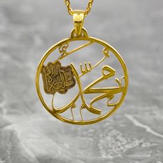 Crafted with exquisite detail and reverence, the Muhammad Written Necklace transcends mere jewelry to embody a sacred symbol of faith. Made of lustrous 925 sterling silver and elegantly plated with 18K gold, this Arabic pendant exudes timeless elegance. For Muslim women seeking a meaningful accessory, this necklace serves as a heartfelt gesture or a personal keepsake. Perfect for everyday wear or special occasions, it seamlessly merges spirituality with style. Embrace the beauty and significance Gold Amulet Jewelry With Polished Finish, Gold Sterling Silver Spiritual Jewelry, Spiritual Gold Sterling Silver Jewelry, Yellow Gold Pendant Jewelry For Blessing, Symbolic Engraved Jewelry For Blessing, Sterling Silver Medallion For Blessing Occasion, Symbolic Gold Jewelry For Blessing, Amulet Style Jewelry With Polished Finish As Gift, Gold Plated Spiritual Round Pendant