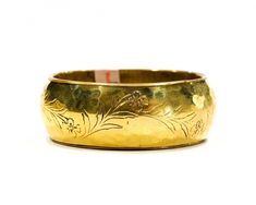 "Lovely hammered brass bangle from the 1970s. Great floral etched design. New old stock, originally from the 1970s. Although new and never used, age has added a touch of tarnish and great character. Inside diameter measures approximately 2.5\" and is 1\" wide. NOTE: The beauty of all ethnic jewelry comes from its distinct rustic feel. There are unique variations in color and texture due to the handmade process. We came across a large supply of authentic 70's India jewelry, once out of stock it w 70s Jewelry, Puka Shell Necklace, Nature Necklace, Brass Bangle, Puka Shell, Hammered Brass, India Jewelry, Tiktok Style, Mother Pearl