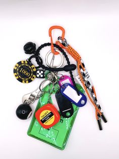 an assortment of key chains and lanyards on a white surface