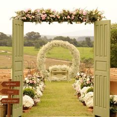 an outdoor ceremony with flowers and greenery