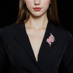 This captivating piece is a celebration of the timeless beauty of roses, brought to life with an array of dazzling stones. The brooch features a delicate rose blossom for a touch of its natural allure. Adjacent to the flower, each gracefully curved leaf adds a touch of organic charm to the design. All of the elements are adorned with an abundance of shimmering stones, carefully selected to enhance their inherent beauty. This versatile accessory can be worn on a lapel, a scarf, or as a centerpiec Luxury Flower Brooches For Wedding, Elegant Rose Brooches, Elegant Rose-colored Brooches, Luxury Pink Brooches For Wedding, Luxury Pink Brooch For Wedding, Luxury Pink Wedding Brooches, Elegant Pink Wedding Brooches, Formal Pink Brooch Lapel Pin, Elegant Rose Gold Lapel Pin Brooch