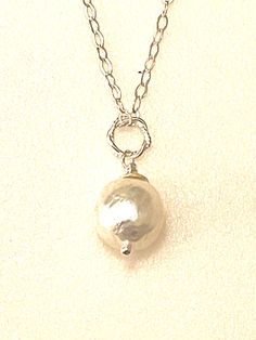 Gorgeous large 12 x 13mm freshwater cultured Kasumi pearl wire wrapped on sparkling sterling silver cable chain.  Beautiful Chinese Kasumi Baroque pearl with characteristic iridescent bumpy surface is creamy white color and highly lustrous. Stunning single pearl displays a gorgeous array of metallic colors in the light. You will receive this exact Pearl.  Pearl is wire wrapped in .925 sterling silver with Karen Hill Tribe .999 silver cap and hangs from sparkling flat cable chain with spring ring clasp. Total pendant length with twisted sterling silver ring is 1 inch. Sterling Silver Pearl Pendant With Round Beads, Sterling Silver Necklace With Pearl Drop And Round Beads, Sterling Silver Necklaces With Pearl Drop And Round Beads, Sterling Silver Jewelry With Pearl Pendant And Round Beads, Baroque Pearl Wire Wrapped Jewelry Gift, Handmade Teardrop Silver Pearl Necklace, Sterling Silver Pearl Necklace With Pearl Drop, Handmade Silver Teardrop Pearl Necklace, Pearl White Wire Wrapped Jewelry For Gift