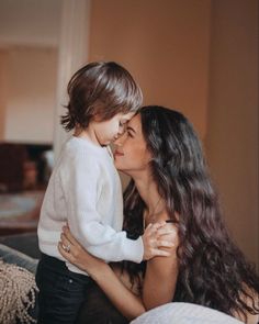 a woman holding a small child in her arms