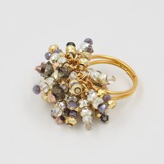 Metallic Caviar Collection Gem Cluster Cocktail Ring in Ingot Pyrite in metallic gold and deep silver shimmer along with accent beads in copper, cobalt and crystal clear Swarovski. Notes: Pyrite (gold, silver, slate), copper, swarovski crystals, moonstones Vermeil gold adjustable band (starting size 6) 14c gold filled wire/hooks/findings  **matching earrings and fringe Necklace available. Adjustable Gold Crystal Ring, Adjustable Jewelry With Faceted Beads For Celebration, Gold Crystal Ring With Bling For Party, Adjustable Faceted Beads Jewelry For Celebration, Gold Bling Crystal Ring For Party, Gold Rings With Bling, Elegant Beaded Rings For Party, Adjustable Multicolor Crystal Ring For Party, Unique Gold Jewelry With Faceted Beads