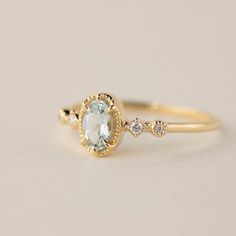 Genuine Aquamarine, oval cut, 6x4mm. Accent diamond: 0.03ctw., G color SI clarity. Band width: approx. 1.3x1.6mm Six prongs bezel setting sit flush to your finger. Made of 100% recycled solid 14k yellow gold, rose gold, or white gold. Please note that colors may vary slightly as they are genuine gemstones. Our Dedication All our jewelry is designed and created by Kat with great attention to details and the entire production from casting, stone setting to finishing takes place in New York, USA. A Oval Aquamarine Diamond Ring Fine Jewelry, Oval Aquamarine Diamond Ring In Fine Jewelry Style, Light Blue Oval Diamond Topaz Ring, Oval Aquamarine Diamond Ring With Accents, Oval Aquamarine Diamond Ring With Diamond Accents, Oval Aquamarine Diamond Ring Gift, Oval Aquamarine Diamond Ring As Gift, Oval Aquamarine Ring With Diamond Accents, Oval Aquamarine Rings With Diamond Accents