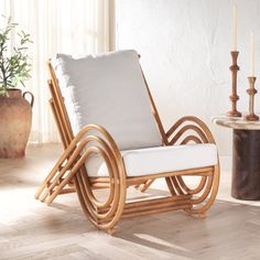 a chair that is sitting in the middle of a room next to a table with candles on it