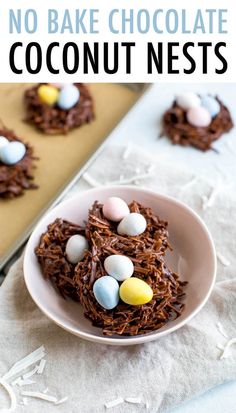 chocolate nests with mini eggs in the middle on a plate next to a cookie sheet