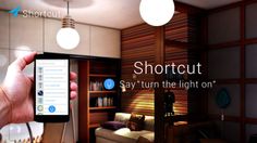 a person holding up a smart phone with the text shortcut say turn the light on
