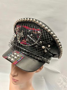 This is a black leatherette captain hat. Well made to a high standard. It has plenty of eye catching detail including metal studs, safety pins , please refer to photos . This is a size 59 cm which fits most size heads. No two hats are created the same. Individual and unique  Thank you for looking Black Steampunk Top Hat For Alternative Fashion, Punk Style High Crown Hat For Cosplay, Punk Style Short Brim Halloween Hat, Punk Short Brim Hats For Halloween, Halloween Punk Style Hat With Short Brim, Punk Style Short Brim Hats For Halloween, Halloween Punk Hat With Short Brim, Edgy Black Hat For Alternative Fashion, Black Alternative Style Hats For Alternative Fashion