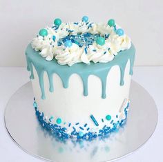 a blue and white cake with sprinkles on it