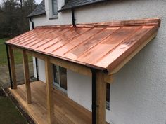 a house with a wooden deck and metal roof