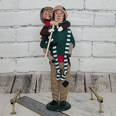 a figurine holding a child on top of a skateboard