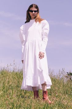 Our designer's favorite dress this season, the Honey Ryder. Featuring the cutest ruffle neck and voluminous puff sleeves. Plus a shirred waistline and ruffle hem for added volume in the skirt. White, 100% Cotton Poplin Black, 100% Cotton Poplin White & Black, 100% Cotton Gingham Seersucker Descano Gardens Print, 96% Polyester 4% Spandex Ruffle Neck Boxy Shape Center Back Spaghetti Tie Closure Voluminous Leg-O-Mutton Long sleeves Shirred Waistline Shirred Ruffle Hem Volume Shirring Side Pockets S Chic Voluminous Puff Sleeve Dress With Ruffles, Billowy Long Sleeve Puff Sleeve Dress For Spring, Spring Puff Sleeve Dress With Bishop Sleeves For Daywear, Spring Daywear Puff Sleeve Dress With Bishop Sleeves, Billowy Puff Sleeve Dress With Gathered Lantern Sleeves, Billowy Lantern Sleeve Dress With Gathered Puff Sleeves, Voluminous Puff Sleeve Dress With Ruffles, Long Sleeve Ruffled Dress With Voluminous Skirt, Long Sleeve Dresses With Ruffles And Voluminous Skirt