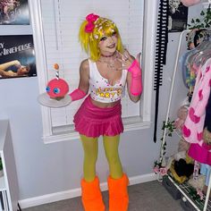 a woman dressed up in a costume and holding a cake