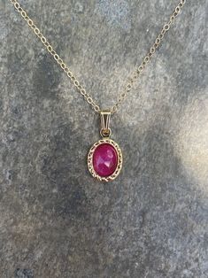 This necklace is handcrafted with an authentic 6x8mm ruby stone in a gold setting. The stone is AAA quality. The chain is 14k gold-filled and will not tarnish easily.  Ruby is an energizing stone that promotes passion and optimism. Each necklace comes in a ribbon-wrapped box, ready to be gifted. If you would like to leave a note for the recipient, you can do so during checkout. Dainty Gold Ruby Jewelry, Gold Ruby Birthstone Jewelry, Oval Gold Birthstone Necklace In 14k Gold, 14k Gold Oval Birthstone Necklace, Gold Oval Birthstone Necklace, Gold Ruby Gemstone Necklace, Dainty Oval Ruby Jewelry, Oval Ruby Necklace With Birthstone, Oval Ruby Birthstone Necklace