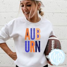 Get ready to show off your Auburn pride with this sweatshirt! With bold block letters and a game day ready design, this women's sweatshirt will elevate your school spirit. Perfect for football season or any day, this sweatshirt is a must-have for any Auburn fan! Tees run true to size. If you have any questions please feel free to ask. Fabric & Care:Machine wash warm or cold with mild detergentDry on normal dryer settingsDo not dry cleanDo not iron over design. If ironing is needed iron on low he Team-colored Hoodie For Game Day In Fall, Team-colored Fall Sports Sweatshirt, Varsity Hoodie For Game Day In Fall, Team-colored Sweatshirt For Sports In Fall, Collegiate White Sweatshirt For College, Collegiate Sweats For College Sports Season, Varsity Hoodie For Game Day, Sporty College Sweatshirt With Team Logo, White Sporty Sweatshirt For Game Day