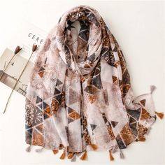 Indulge in the splendor of the season with our Autumn Couture Viscose Shawl Scarf. This high-quality piece features a striking Aztec geometric pattern, crafted from luxurious cotton viscose pashmina, and delicately wrapped in a transparent plastic bag. Available in a versatile 180*90cm size, with a weight of approximately 130g, this fashion statement is perfect for both retail and wholesale. Embrace elegance and sophistication with this exquisite addition to your wardrobe. (Product size: 180cm*90cm; please note that there may be slight measurement discrepancies due to manual handling.) Snood Pattern, Hijab Caps, Kimono Coat, Scarf Material, Modest Swimwear, Muslim Hijab, Hijab Scarf, Shawl Scarf, Pashmina Scarf