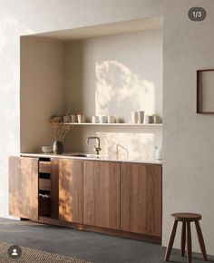 a kitchen with wooden cabinets and white walls