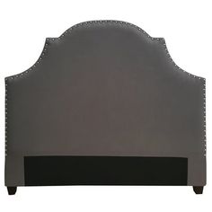 an upholstered headboard with studded trim