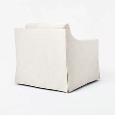 an upholstered white chair on a white background with no one in it or someone else