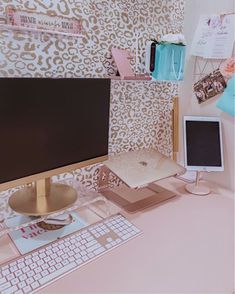 a computer monitor sitting on top of a desk next to a keyboard and mouse pad