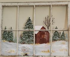 an old window with a painting of a barn and trees in the snow behind it