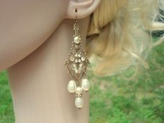 These antique gold bridal earrings are created with highly detailed luxurious antique brass filigree drops in which I placed Swarovski golden shadow crystals, Swarovski ivory pearls and Swarovski rondelles. These dangle dramatically 3-1/2 inches from top of ear wire to bottom of center pearl drop. This is an original design by © Treasures by Agnes PLEASE ALLOW 10 DAYSFOR COMPLETION. All pieces come beautifully gift wrapped. Custom orders welcome. ALL ORDERS ARE SHIPPED VIA USPS FIRST CLASS WITH Chandelier Earrings Wedding, Rose Gold Chandelier Earrings, Bridal Jewelry Pearl, Long Crystal Earrings, Pearl Teardrop Earrings, Teardrop Bridal Earrings, Long Bridal Earrings, Rose Gold Bridal Earrings, Pearl Chandelier Earrings