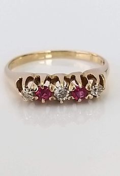 A beautiful early 20th century 18ct solid gold, ruby and diamond ring. The superb round shaped rubies are a lovely rich red colour, complemented by bright, well matched & sparkly old cut diamonds. The gallery and claws are in superb condition as is the entire piece. ▪ Overall Condition: Excellent ▪ Metal: 14ct Gold ▪ Gem: Diamond ▪ Gem: Ruby ▪ Gem Cut: Oval ▪ Gem Colour: Red ▪ Ring Size UK: M ▪ Ring Size US: 6.50 ▪ Resizing: Quotation Available ▪ Marked: 14k ▪ Weight: 2.70gms ▪ Insurance Estimate: £775 ▪ Payment Layaway Plan Available: Yes ▪ Full Detailed Appraisal: Quotation Available As a qualified Gemmologist and Jeweller with over 20 years experience in the jewellery  industry, each jewel is chosen for its  'quality, beauty and interest'... As a Consultant in a contemporary jewellery g Antique Ruby Ring With Single Cut Diamonds, Vintage Ruby Rings With Single Cut Diamonds, Antique Red Diamond Ring With Rose Cut Diamonds, Classic Red Ruby Ring With Single Cut Diamonds, Red Victorian Diamond Ring, Classic Round Ruby Ring For Valentine's Day, Victorian Yellow Gold Ruby Ring With Single Cut Diamonds, Formal Ruby Ring With Single Cut Diamonds, Vintage Ruby Ring With Single Cut Diamonds