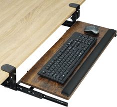 a computer desk with a keyboard, mouse and monitor on it's side tray