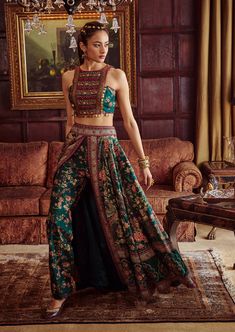 Editor's Note Featuring a classically feminine silhouette, hand painted and printed with floral motifs in vibrant colours. It is intricately adorned with embroidery and coin-work. The skirt is a combination of palazzo pants and wrap around skirt. Fabric: Blouse & lehenga: viscose silk Color: Green Components: Blouse and lehenga Occasion: Wedding Guest and festive Disclaimer: Product color may slightly vary due to photographic lighting sources or your monitor setting. Care: Dry Clean Only About t Kurta Set Designs Latest, Indian Skirt Designs, Skirt Blouse Designs Latest, Palazzo Lehenga, Modern Lengha, Lehenga Designs Latest, Latest Saree Designs, Delhi Fashion, Moda Peru