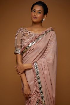 Onion pink saree, highlighted with 3D floral embroidery, petal frilled edges on the border with mirror embroidery. Paired with a bishop sleeve padded blouse with all over 3D flower embroidery.
Components: 2
Pattern: Embroidery
Type Of Work: 3D Flower Embroidery
Neckline: Boat Neck
Sleeve Type: Bishop Sleeves
Fabric: Tulle and Georgette
Color: Pink
Other Details: 
Padded blouse
Petal frilled edges
Occasion: Reception,Sangeet - Aza Fashions Elegant Pink Blouse With Sheer Dupatta, Tissue Silk Party Blouse For Weddings, Wedding Pink Blouse With Mirror Work, Elegant Embellished Pink Blouse Piece, Pink Tissue Silk Blouse With Traditional Drape, Elegant Pink Blouse With Mirror Work, Pink Embellished Blouse For Wedding, Pink Tissue Silk Blouse Piece With Mirror Work, Pink Embellished Blouse With Traditional Drape