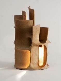 a sculpture made out of clay with a light on the top and one in the middle