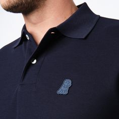 This men's classic piquŽ polo is a timeless must-have for any wardrobe. Crafted from the finest breathable Pima cotton, it features a sleek silhouette with an embroidered James Bark logo.Made in Peru100% Pima CottonEmbroidered James Bark LogoRibbed FinishesSide vents for added comfort Cotton Polo Shirt With Logo Patch, Casual Navy Polo Shirt With Embroidered Logo, Casual Polo Shirt With Logo Patch, Casual Cotton Polo Shirt With Logo Patch, Classic Navy Fitted Polo Shirt, Classic Fitted Navy Polo Shirt, Classic Navy Polo Shirt With Ribbed Collar, Classic Navy Cotton Polo Shirt, Polo Classic