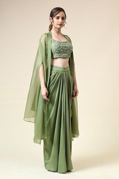 Tropical green blouse embroidered with beads and sequin in floral motifs. Paired with matching draped skirt and cape. - Aza Fashions Green Draped Silk Sets, Green Draped Sets With Zari Work, Green Draped Choli For Reception, Embellished Pista Green Georgette Pre-draped Saree, Embellished Pista Green Pre-draped Saree In Georgette, Traditional Green Draped Choli, Green Hand Embellished Sets In Traditional Drape, Fitted Green Embellished Choli, Green Hand Embellished Sets With Traditional Drape