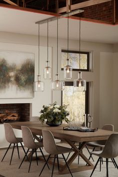 a dining room table with chairs and a large painting on the wall behind it in front of a fireplace