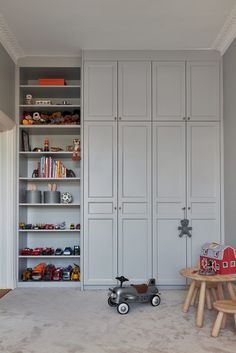 a child's room with toys and bookshelves