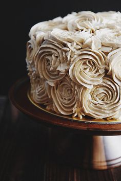 a birthday cake with white frosting and flowers on it that says wishing you the happest of birthdays