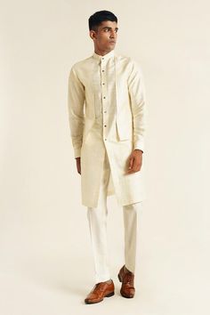 Ivory full sleeve front open kurta with double panel and edge detailing. Paired with pant cut pyjama.
Components: 2
Type Of Work: Plain
Neckline: Band collar
Sleeve Type: Full sleeves
Fabric: Raw Silk
Color: Ivory
Other Details: 
Front button detailing
Cuff sleeve hem
Occasion: Sangeet - Aza Fashions Full Sleeve Kurta, Kurta Set For Men, Types Of Work, Desi Fashion, Band Collar, Kurta Set, Full Sleeves, Color Ivory, Raw Silk