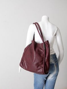 "This is a vintage Neiman Marcus leather tote bag.  The large soft body tote features rolled leather piping trim with metal accents at the tops of the handles.  Tone on tone topstitching stripes the bag.  Interior is lined.  CONDITION In good condition with wear consistent with age and use.  MEASUREMENTS Width:  13\"  ..  33 cm Height:  14\"  ..  35.6 cm Depth: 5.5\"  ..  14 cm Strap Drop:  10\"  ..  25.4  cm 72228" Burgundy Tote Bag, Burgundy Satchel With Handles For Shopping, Burgundy Soft Leather Bag With Double Handle, Burgundy Double Handle Satchel With Large Capacity, Burgundy Bag With Double Leather Handles, Burgundy Soft Leather Shoulder Bag With Double Handle, Burgundy Bags With Leather Double Handles, Burgundy Satchel With Large Capacity For Fall, Modern Burgundy Tote Shoulder Bag