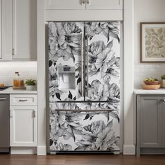 the refrigerator is decorated with black and white flowers